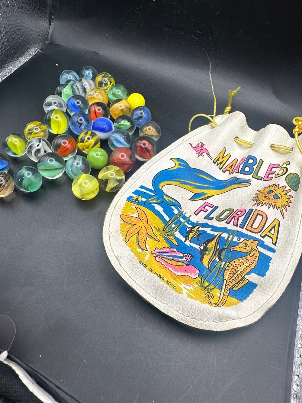 Kids Florida souvenir marble pouch with marbles shown